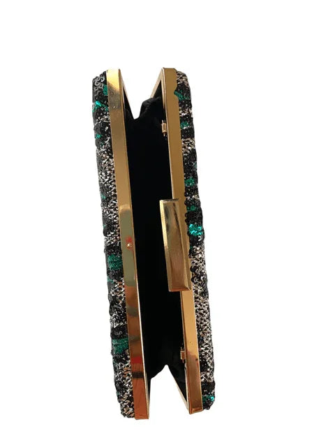 Side view of glittering black and green sequin clutch purse with gold trim
